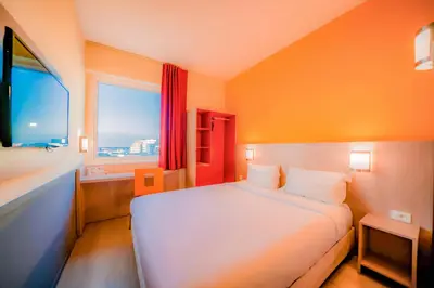 a bedroom with a white bed and a window at Premiere Classe Casablanca Centre Ville in Casablanca