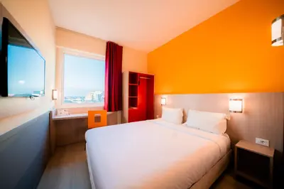 a bedroom with a white bed and a window at Premiere Classe Casablanca Centre Ville in Casablanca