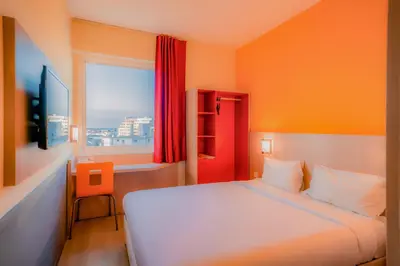 a bedroom with a white bed and a window at Premiere Classe Casablanca Centre Ville in Casablanca
