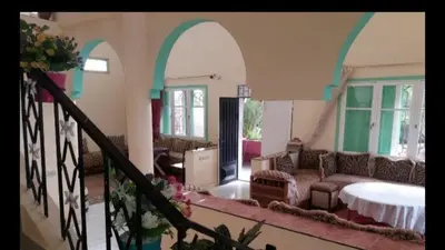 a living room with a couch and a table at villa waresa in Derroua