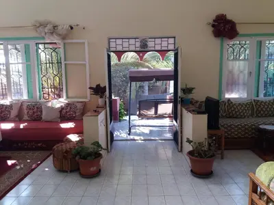 a living room with a mirror and a couch at villa waresa in Derroua