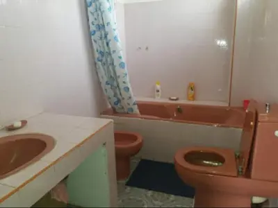 a bathroom with a sink and a toilet and a tub at villa waresa in Derroua