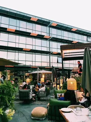 a group of people sitting in chairs in front of a building at ONOMO Hotel Casablanca City Center in Casablanca