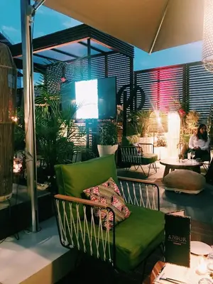 a living room with a green couch on a patio at ONOMO Hotel Casablanca City Center in Casablanca