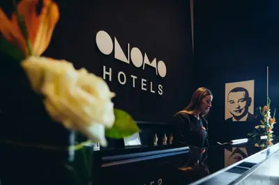 a woman standing in front of a mirror at ONOMO Hotel Casablanca City Center in Casablanca