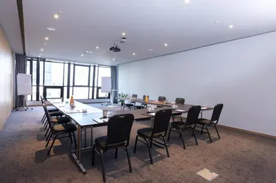 a conference room with a long table and chairs at ONOMO Hotel Casablanca City Center in Casablanca