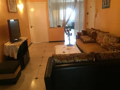 a living room with a couch and a tv at Property in a quiet area close to the train station and town in Casablanca