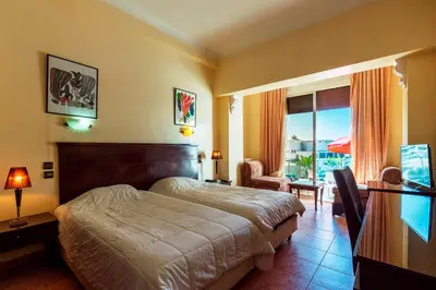 a hotel room with a bed and a balcony at Hotel Bellerive in Casablanca