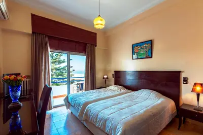 a bedroom with a bed and a large window at Hotel Bellerive in Casablanca