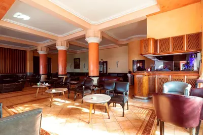 a restaurant with chairs and tables and a bar at Hotel Bellerive in Casablanca