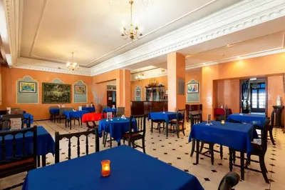 a dining room with blue tables and chairs at Hotel Bellerive in Casablanca