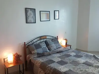 a bedroom with a bed and two lamps on tables at home zen in Rabat