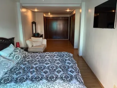 a bedroom with a bed and a couch and a chair at home zen in Rabat