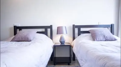 two beds sitting next to each other in a bedroom at Luxueux Appart Au Triangle D'Or Casablanca in Casablanca