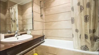 a bathroom with a sink and a shower curtain at Luxueux Appart Au Triangle D'Or Casablanca in Casablanca
