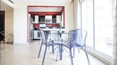 a dining room table and chairs in a kitchen at Luxueux Appart Au Triangle D'Or Casablanca in Casablanca