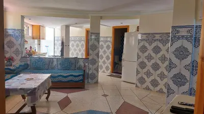 a kitchen with blue and white tiles on the walls at Dream House Sidi Rahal Beach in Sidi Rahal