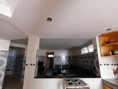 a kitchen with a stove top oven in a room at Dream House Sidi Rahal Beach in Sidi Rahal
