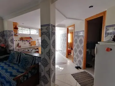 a kitchen and a living room with a refrigerator at Dream House Sidi Rahal Beach in Sidi Rahal