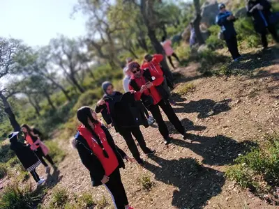 a group of people walking on a dirt road at reda land in O Ben Slimane