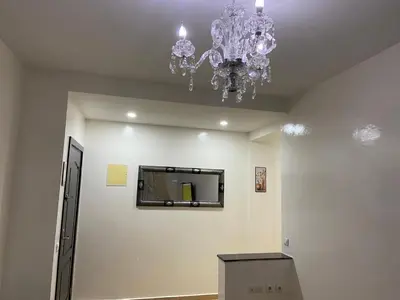 a room with a chandelier hanging from the ceiling at Mohammed V Airport HOME in Deroua