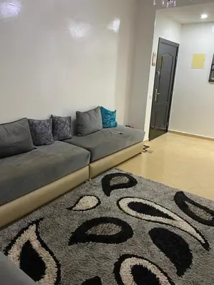 a couch in a living room with a carpet at Mohammed V Airport HOME in Deroua