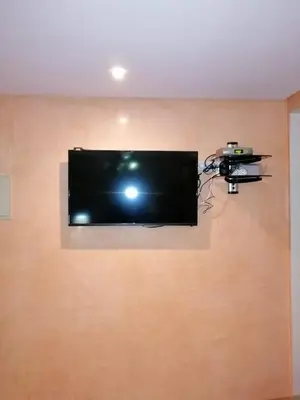 a flat screen tv hanging on a wall at Mohammed V Airport HOME in Deroua