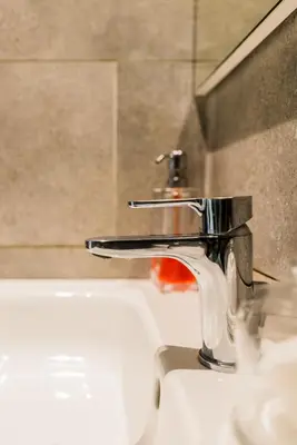 a sink with a faucet in a bathroom at COMFORTABLE & ELEGANT FLAT IN A LIVELY PLACE by ShortstayMaroc in Casablanca