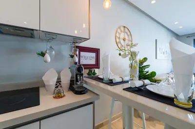 a kitchen with white cabinets and a counter top at COMFORTABLE & ELEGANT FLAT IN A LIVELY PLACE by ShortstayMaroc in Casablanca