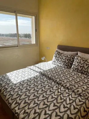 a large bed in a bedroom with a window at Airport to Comme à la maison 1 in Nouaseur