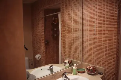 a bathroom with a sink and a tub and a mirror at Airport to Comme à la maison 1 in Nouaseur