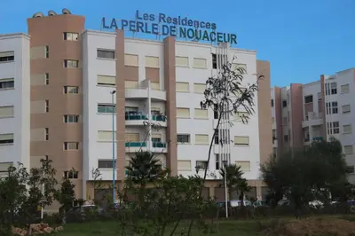 a building with a sign on top of it at Airport to Comme à la maison 1 in Nouaseur
