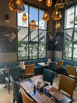 a restaurant with tables and chairs and windows at Yto boutique Hotel in Casablanca