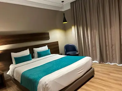 a bedroom with a large bed and a chair at Yto boutique Hotel in Casablanca