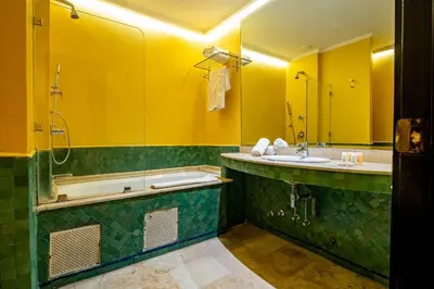 a bathroom with a tub and a sink and a shower at Diwan Casablanca Hotel & Spa in Casablanca