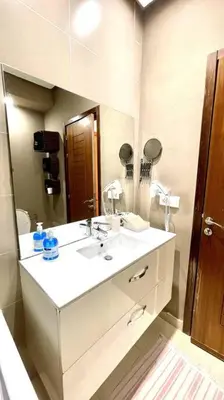 a bathroom with a white sink and a mirror at Taj nouaceur aéroport Mohamed V in Nouaseur