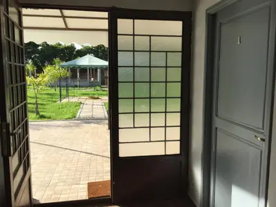 an open door with a view of a yard at Palm Grove Farm in Tit Mellil