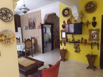 a living room with yellow walls and a table at appartement a casablanca in Casablanca