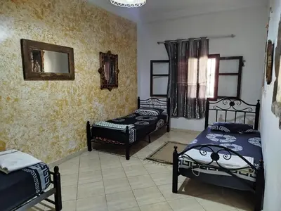 a bedroom with two beds and a mirror at appartement a casablanca in Casablanca