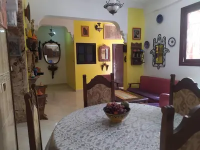 a dining room with a table with a bowl of fruit on it at appartement a casablanca in Casablanca