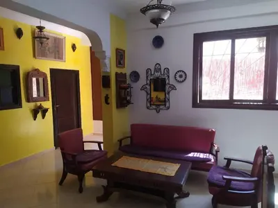 a living room with a couch and chairs and a window at appartement a casablanca in Casablanca