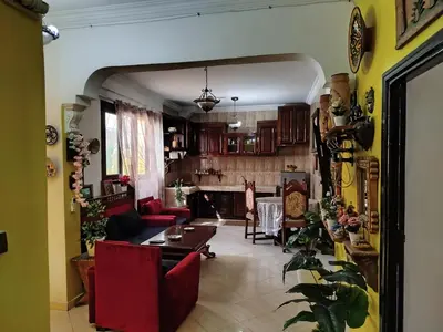 a living room with a couch and a table at appartement a casablanca in Casablanca