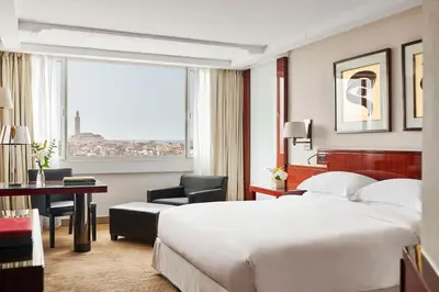 a hotel room with a bed and a desk and a window at Hyatt Regency Casablanca in Casablanca