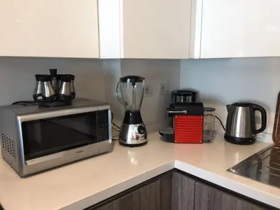 a kitchen counter with a microwave and a blender at luxury apartment in Marina Casablanca in Casablanca