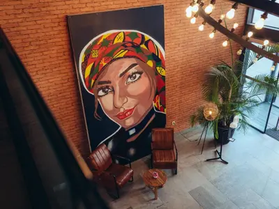 a large painting of a woman on a wall at ONOMO Hotel Casablanca Sidi Maarouf in Casablanca
