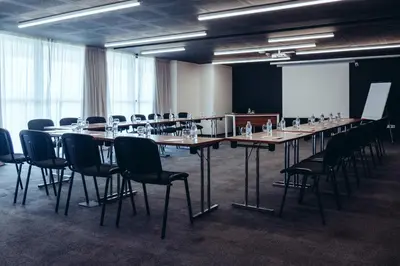 a conference room with a long table and chairs at ONOMO Hotel Casablanca Sidi Maarouf in Casablanca
