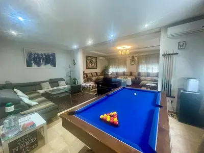 a living room with a pool table in it at Au Cœur Des Plages de Rabat in Oulad Kerroum