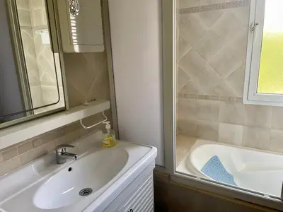 a bathroom with a sink and a shower and a tub at Au Cœur Des Plages de Rabat in Oulad Kerroum