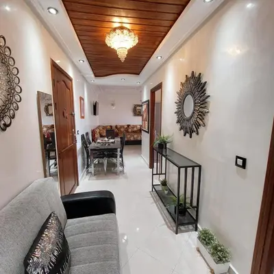 a living room with a couch and a table at Appartement avec terrasse au cœur du centre-ville de Rabat in Rabat