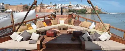 a boat with couches and pillows on the deck at Appartement avec terrasse au cœur du centre-ville de Rabat in Rabat